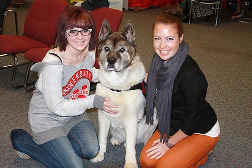 SCC Psychology/Sociology Club members Krista Burks, Human Services major, and Kaylie Rank, Medical Laboratory Technology major, enjoy time with the Healing Hearts therapy dogs on Tuesday.