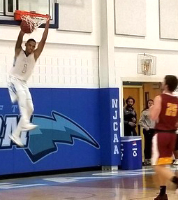 Jalen Wilkins-McCoy dunks against Hesston during play on Saturday, Nov. 25.